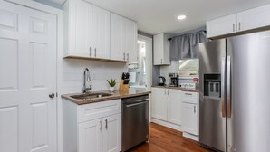 A modern kitchen with white cabinets, stainless steel appliances, and a wooden floor. - 2 BEDROOM APARTMENT IN BRISTOL NEAR PLAINVILLE  (Bristol)