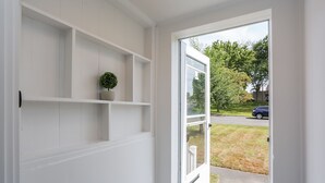 A white interior with a door leading to a view of a street and greenery outside. - 2 BEDROOM APARTMENT IN BRISTOL NEAR PLAINVILLE  (Bristol)