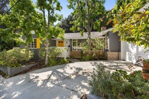 Enjoy a serene retreat in a beautifully maintained garden surrounded by lush plants and shrubs.