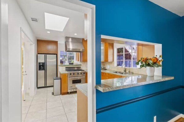 Enjoy cooking in this well-equipped kitchen with a central island and stainless steel appliances.