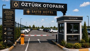 A hotel parking entrance with a security booth, a sign for Safir Hotel, and a camera system. - Safir Hotels Çorlu (Corlu)