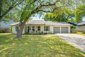 A single-story house with a front porch, a garage, and a well-maintained lawn.