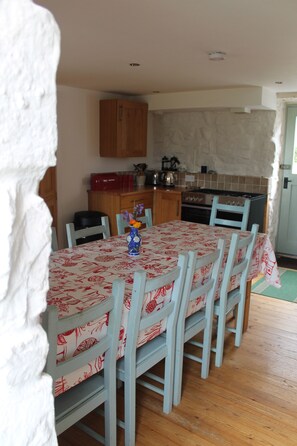 Cozy dining area with a table for four, complete with a stove, oven, and ample storage.