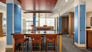 A conference room with a glass table, four wooden chairs, and a central seating area. - Holiday Inn Express & Suites Hayward - Castro Valley by IHG (Hayward)