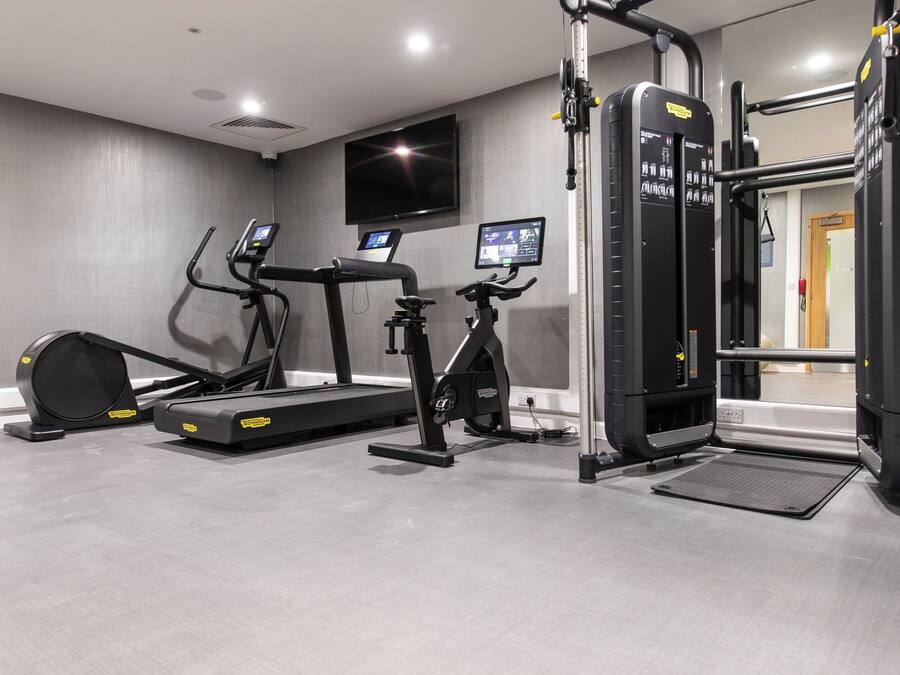 A gym with treadmills, an elliptical, and a weight machine.