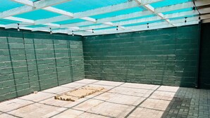 A room with a tiled floor, green brick walls, and a skylight. - Lovely 1 bedroom Loft in the Heart of Walvisbay. (Walvis Bay)