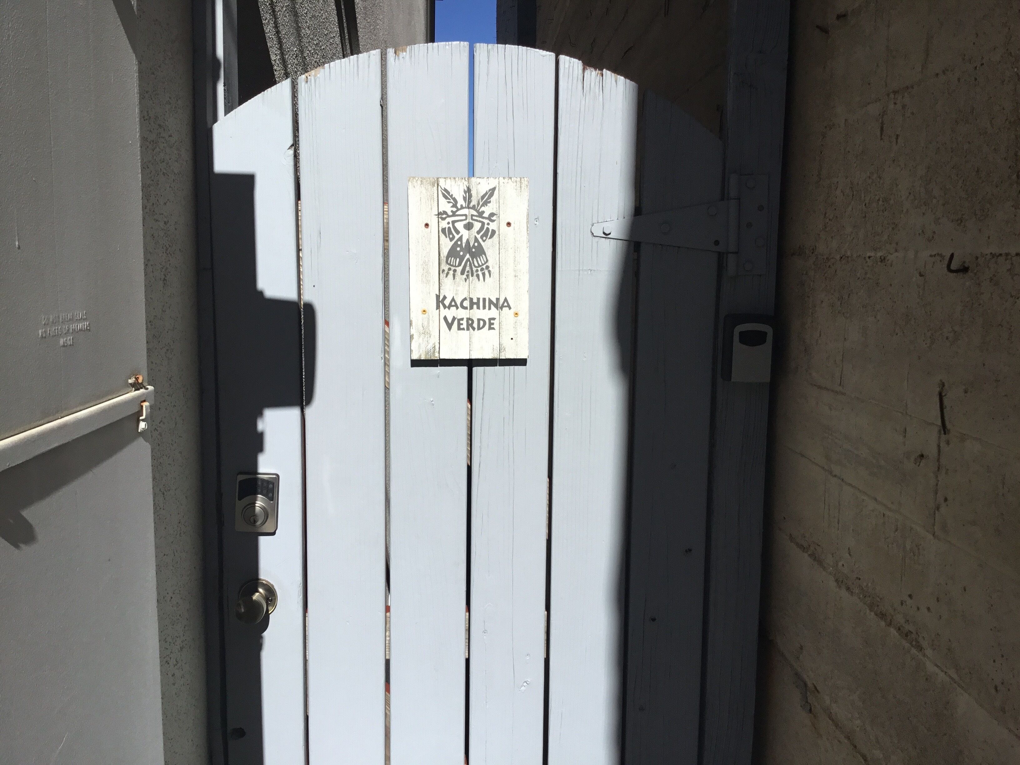 Ein hölzernes Tor mit einem Schild, auf dem 'Kachina Verde' steht.