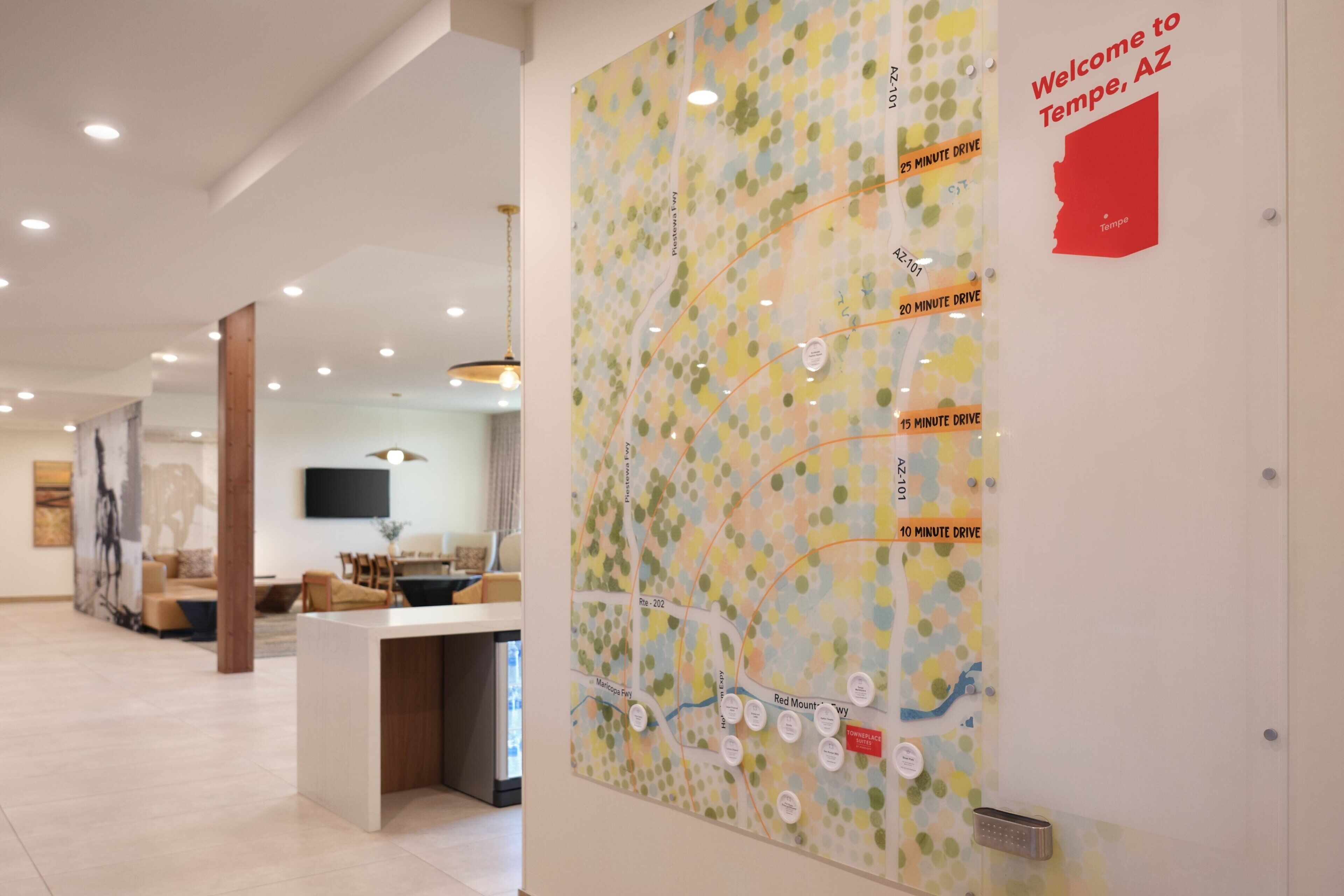 A lobby with a map on the wall indicating drive times to Tempe, AZ.