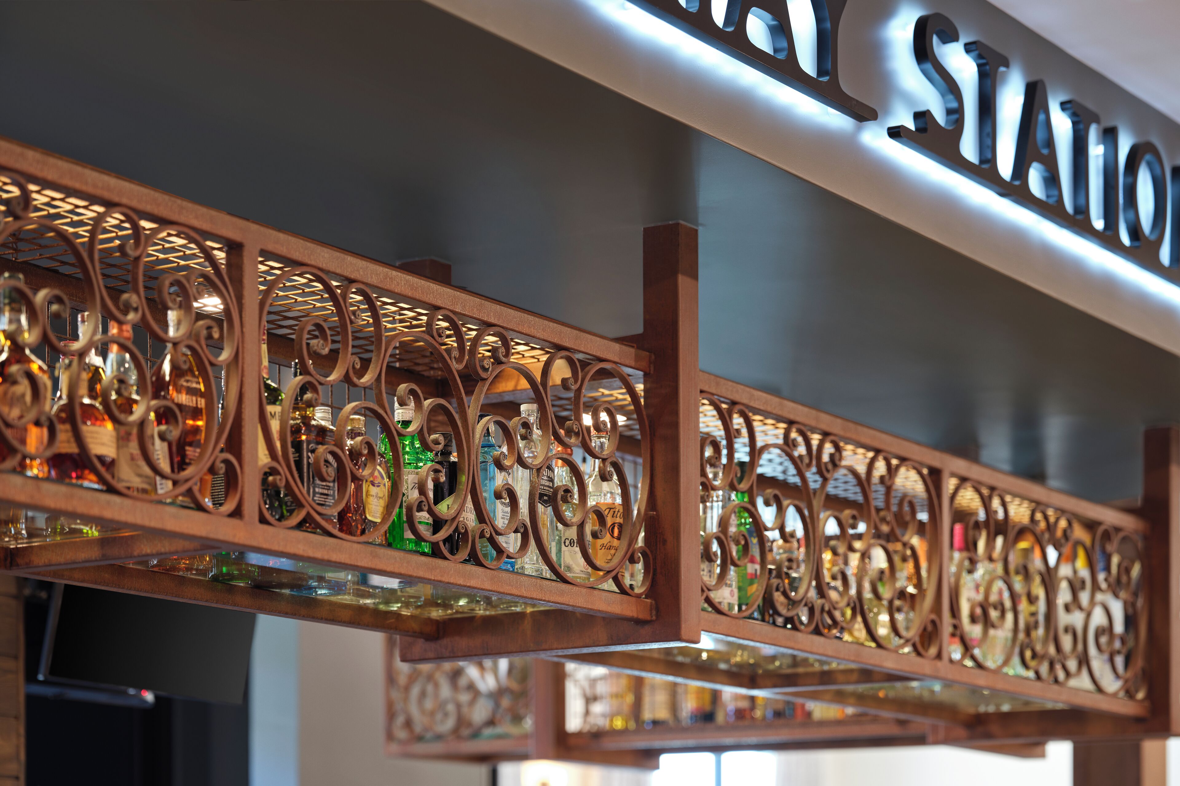 A bar area with a decorative metal railing and a sign above that reads "BAR STATION".