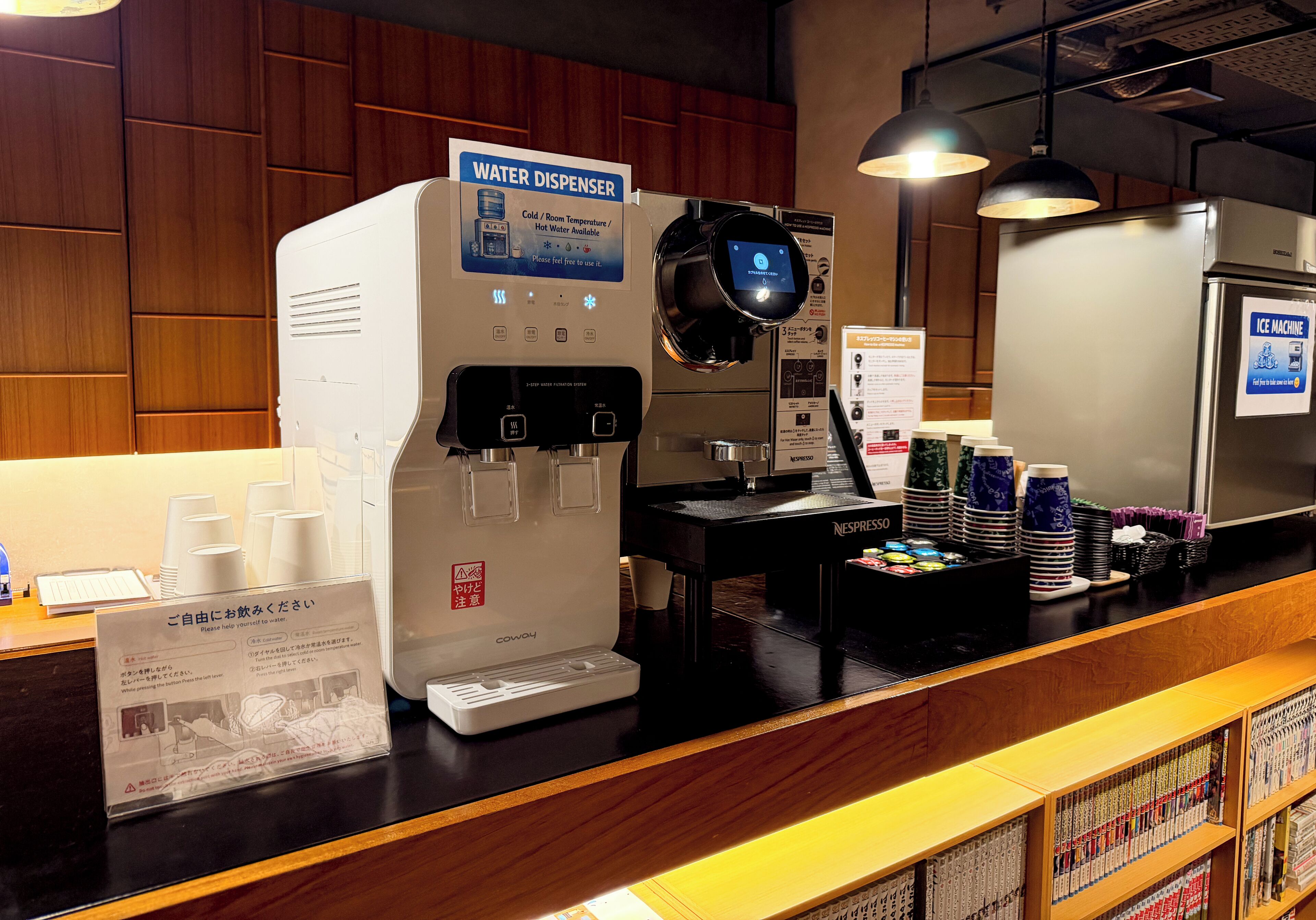 A water dispenser, an ice machine, and a coffee machine in a cafe setting.
