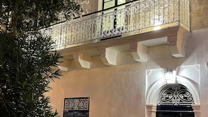 A building with a balcony, a black door, and a light fixture. - Room in Guest Room - "the 10 Square" - A Townhouse Situated in the Heart of Siggiewi Village Square (Siggiewi)
