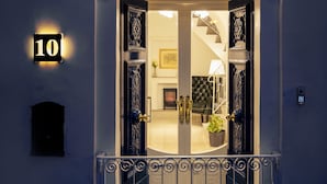 A well-lit entrance with an ornate metal gate, a number sign '10', and a staircase leading inside. - Room in Guest Room - "the 10 Square" - A Townhouse Situated in the Heart of Siggiewi Village Square (Siggiewi)