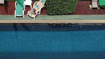 Una piscina con borde de azulejos y una banda verde.