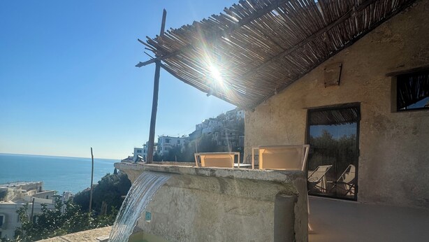 A concrete structure with a water feature, outdoor seating, and a view of the sea. - Alma Domus ancient house recently opened in Amalfi (Amalfi)
