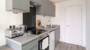 A modern kitchen with a built-in oven, a stovetop, and a sink.