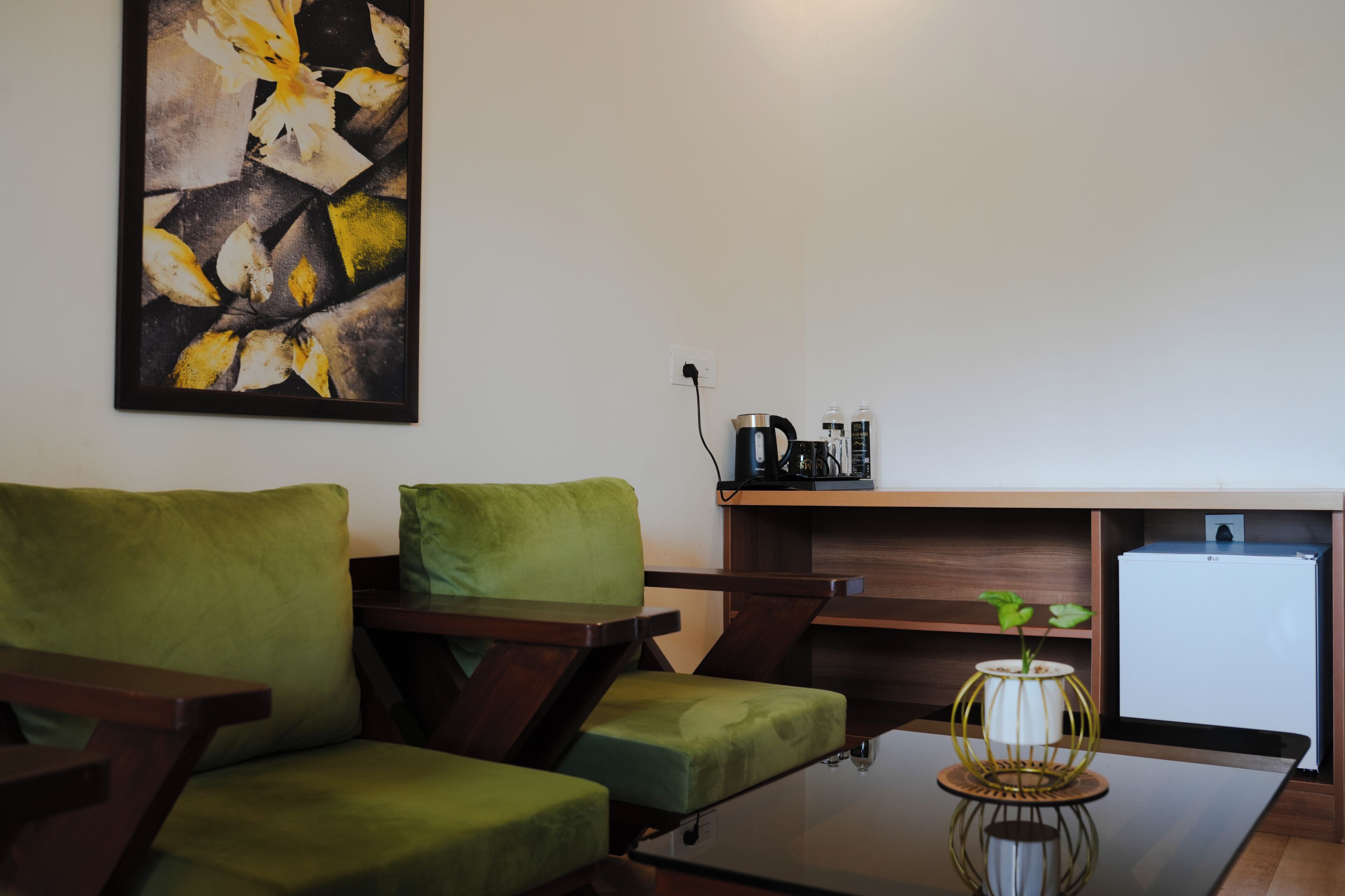 A modern living area with a sofa, a coffee table, and a small refrigerator.