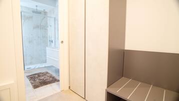 A bathroom with a shower, a toilet, and a sink.