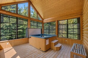 A wooden cabin with a hot tub, large windows, and a wooden deck. - Fiddler Lake Resort - Deer 48 (Mille-Isles)