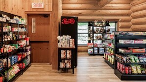 A store interior with wooden walls, shelves stocked with snacks, and a Pepsi refrigerator. - Fiddler Lake Resort - Rabbit 57 (Mille-Isles)