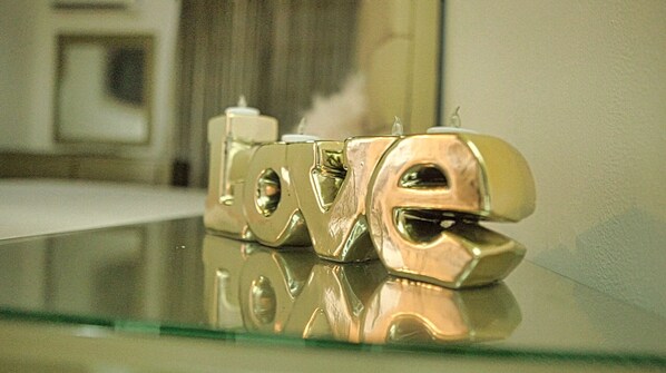 A reflective surface with the word "LOVE" in a metallic, stylized font. - Premium Space In Santiago- 5 Min Away From Airport (Puñal)