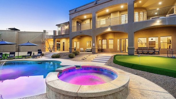 A multi-story building with a swimming pool, hot tub, and a putting green. - Luxury Oasis Heated Pool & Spa* - 7BR Luxury Estate w/ Panoramic Mountain Views! (Mesa)
