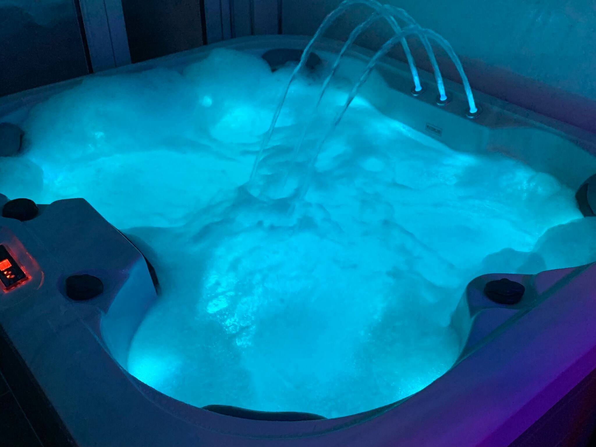 A hot tub with a digital control panel and multiple water jets.