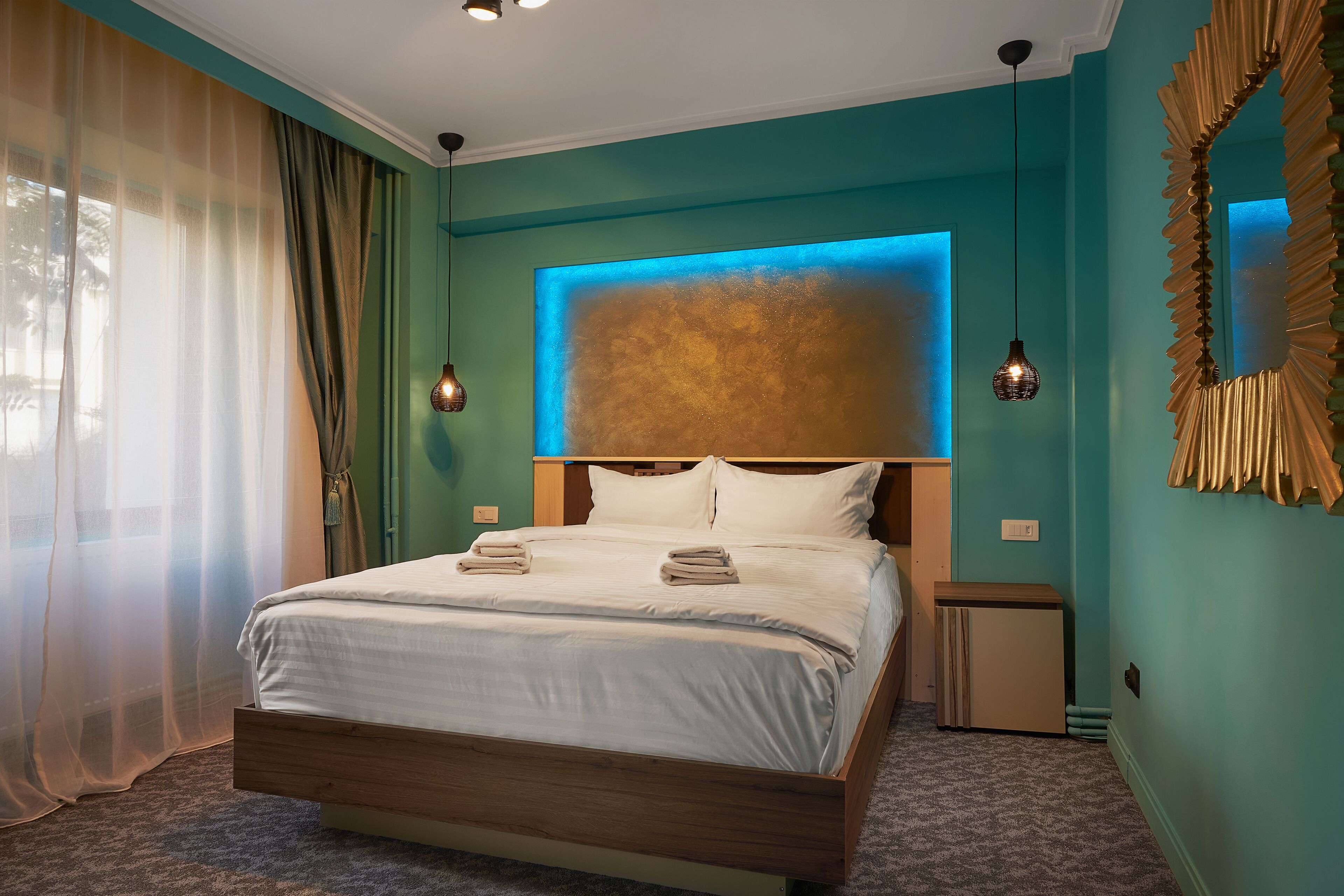 A neatly made bed with a wooden frame, a headboard with a textured panel, and a bedside table with a lamp.