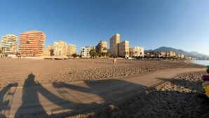 A beach with a row of high-rise buildings in the background. - Poseidón. Beachfront apartment (Fuengirola)