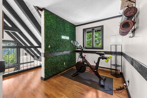 A modern room with a green wall, a window, and a ceiling with skylights.