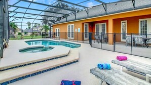 A covered outdoor area with a swimming pool, lounge chairs, and a patio with tables and chairs. - Disney Dream! 10 Mins Away+Game Room, Pool & Hot Tub! - 101 Happy Memories Villa (Kissimmee)