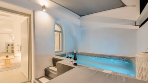 A modern bathroom with a bathtub, a shower, and a toilet. - Tiara Suites (Santorini)