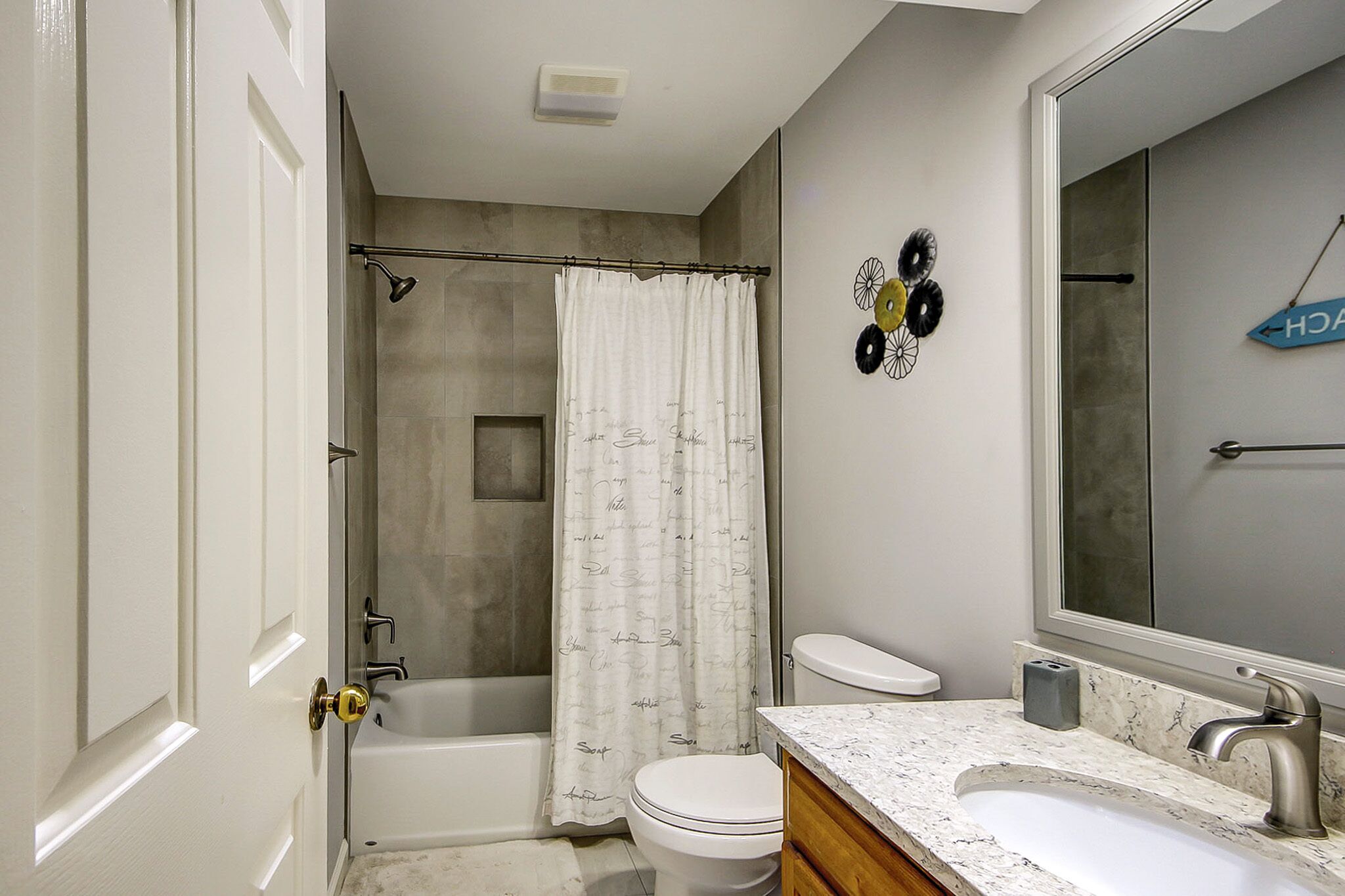 A bathroom with a bathtub, toilet, and sink.