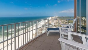 Un balcon avec vue sur la plage et l’océan.