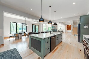 Enjoy cooking in this well-lit kitchen with a central island and integrated appliances.