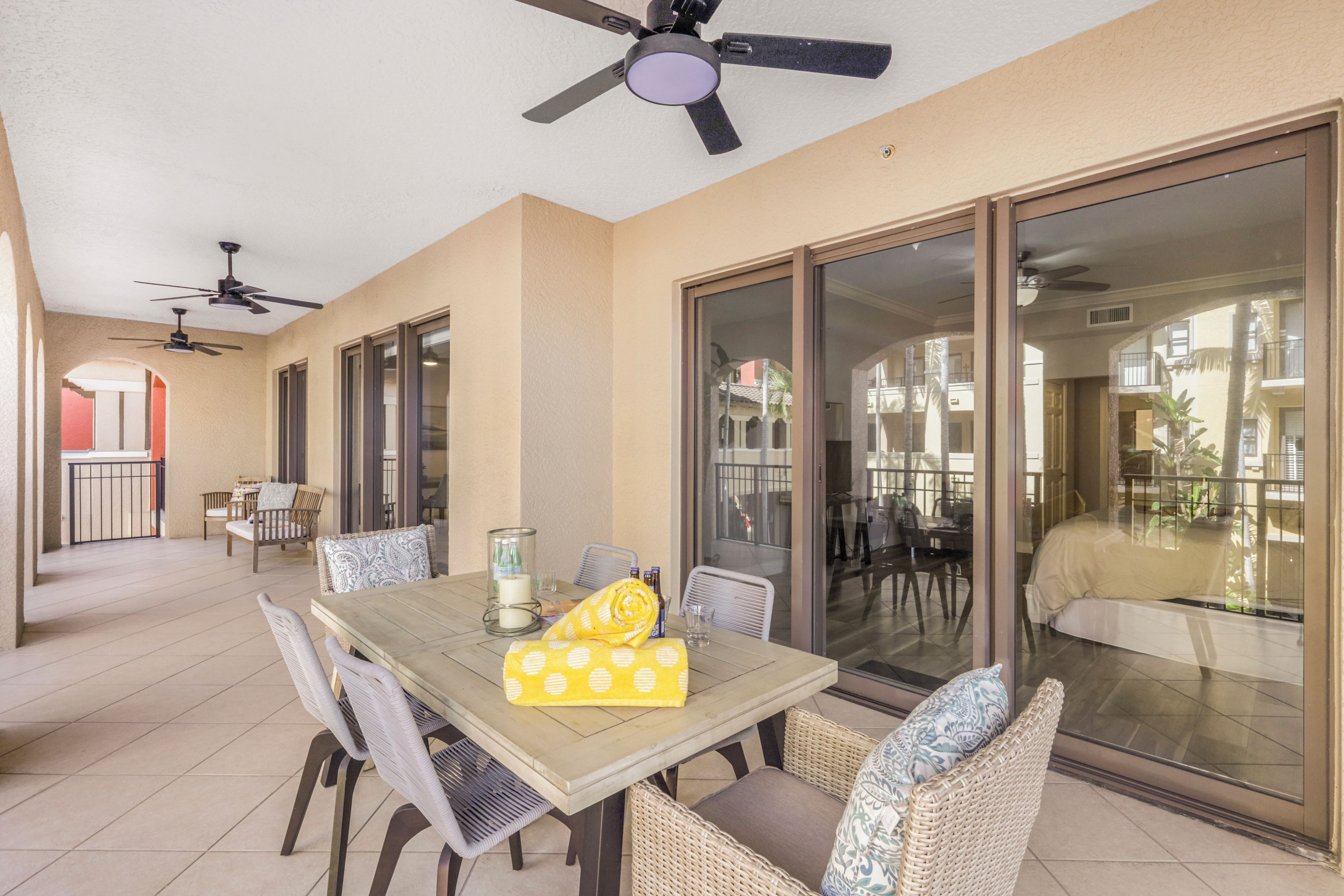 A dining area with a table, chairs, and ceiling fans.