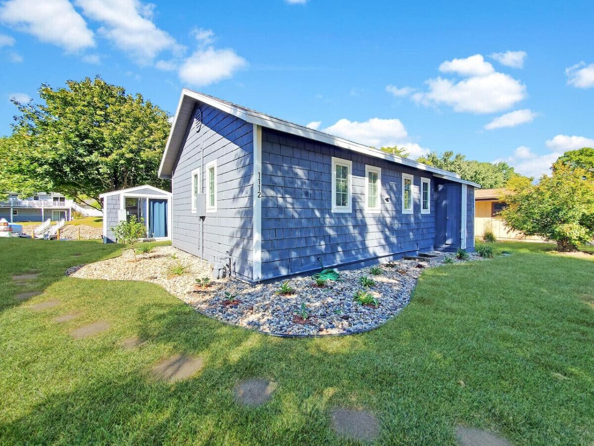 A single-story house with a gabled roof, a small front porch, and a well-maintained lawn.