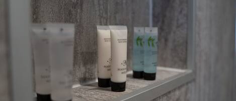 A shelf with several bottles of body lotion.