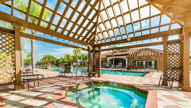 A covered pool area with a hot tub, lounge chairs, and a poolside bar. - Bellavida Resorts 9 Themed bd Private Pool Disney (Kissimmee)
