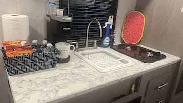 Fridge, microwave, coffee/tea maker, cookware/dishes/utensils