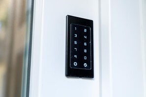 A keypad lock on a door. - Modern Apartment in Via Carloni by Wonderful Italy (Como)