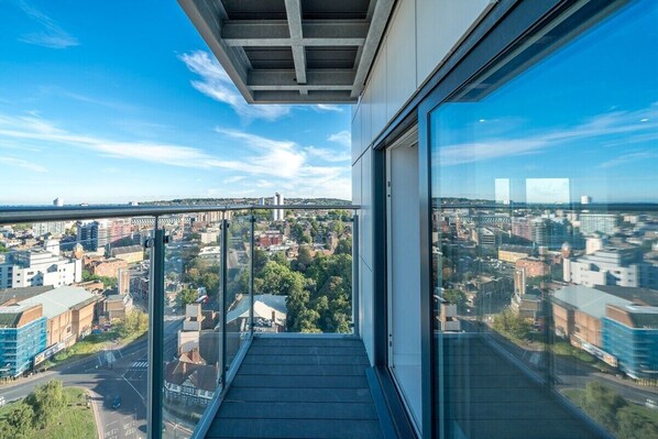 A high-rise building with a glass balcony overlooking a cityscape. - Beautiful apartment located next to the River Thames  (Greater London)