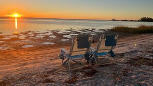 Two beach chairs facing the ocean with a sunset in the background. - Bay view Historic home walking to St. Joseph Bay and Downtown.  (Port St. Joe)