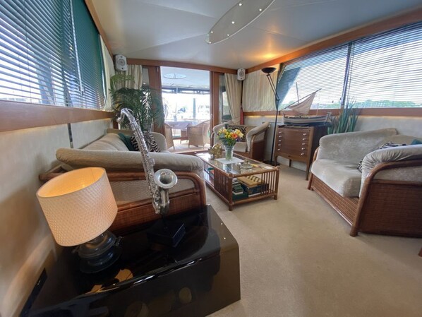 A cozy interior with a sofa, a coffee table, and a lamp.