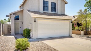 A two-story house with a garage, a satellite dish, and a small garden. - North Phoenix Home! Great Location + Private Patio (Phoenix)