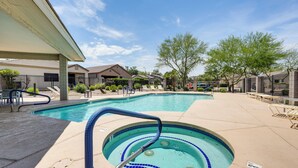A swimming pool with a hot tub, lounge chairs, and a covered area. - Phoenix Home on Golf Course: Pool & Hot Tub Access (Phoenix)