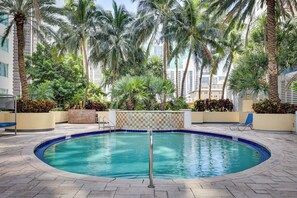 A swimming pool surrounded by palm trees and a tiled deck. - Miami Vacation Rental w/ Balcony, Pool & Hot Tub! (Miami)