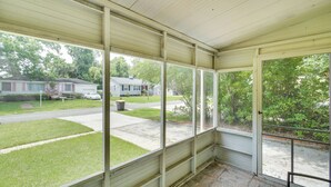 A covered porch with a view of a residential street and houses. - Jacksonville Vacation Rental ~ 7 Mi to Downtown! (Jacksonville)