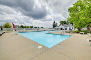 A swimming pool with a white fence, a lifeguard chair, and a small building in the background. - 3 Living Areas & Community Pool: Camby Retreat (Camby)