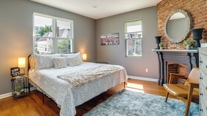 A bedroom with a large bed, a fireplace, and a view of the outside. - Family-friendly Shadyside Gem Near Dtwn Pittsburgh (Pittsburgh)