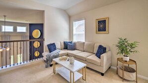 A living room with a beige sofa, a white coffee table, and a small side table with a plant. - Houston Home w/ Private Yard - 16 Mi to Dtwn (Houston)